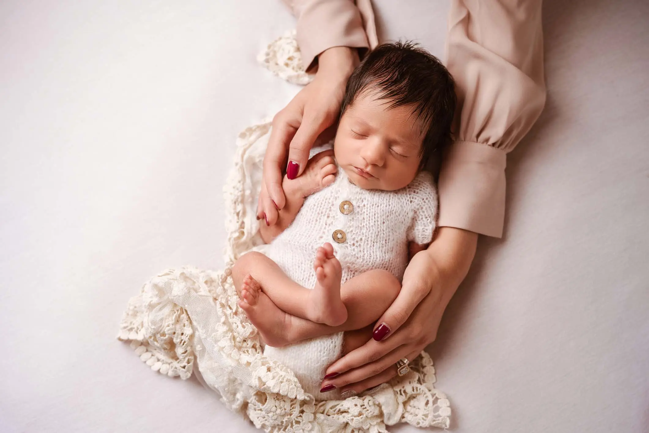 Newborn baby photographed in warm soft light