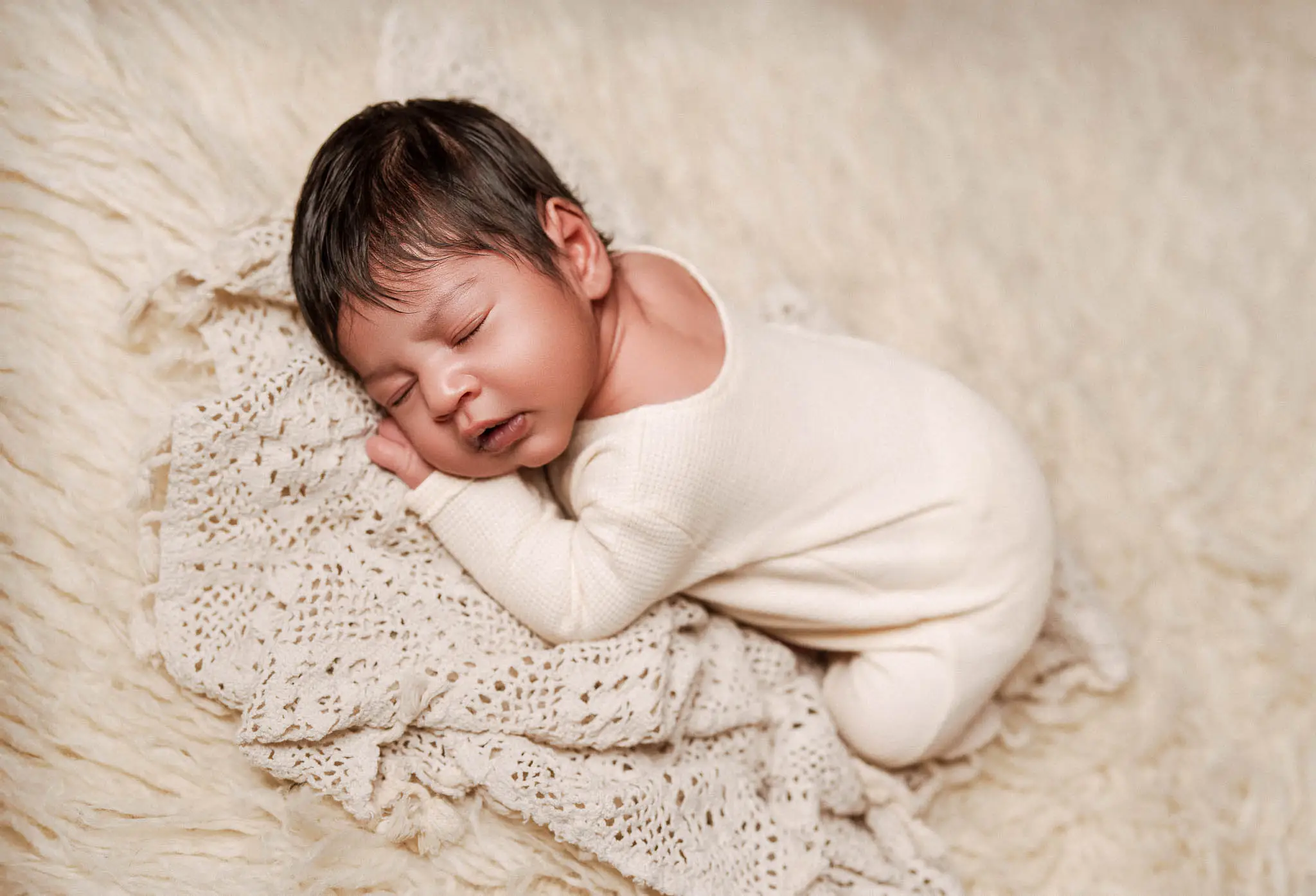 Newborn baby photographed at home with soft styling